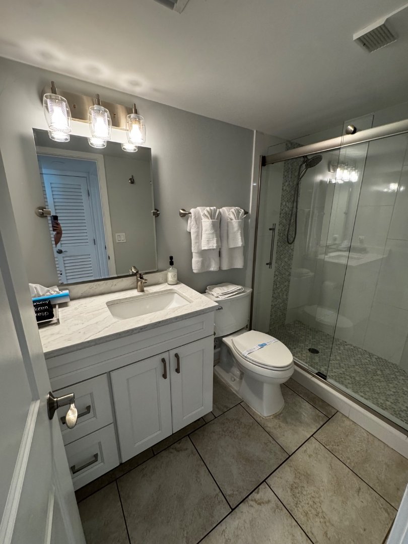 Polished bathroom vanity, mirror, and walk-in shower after a MOR Clean deep clean