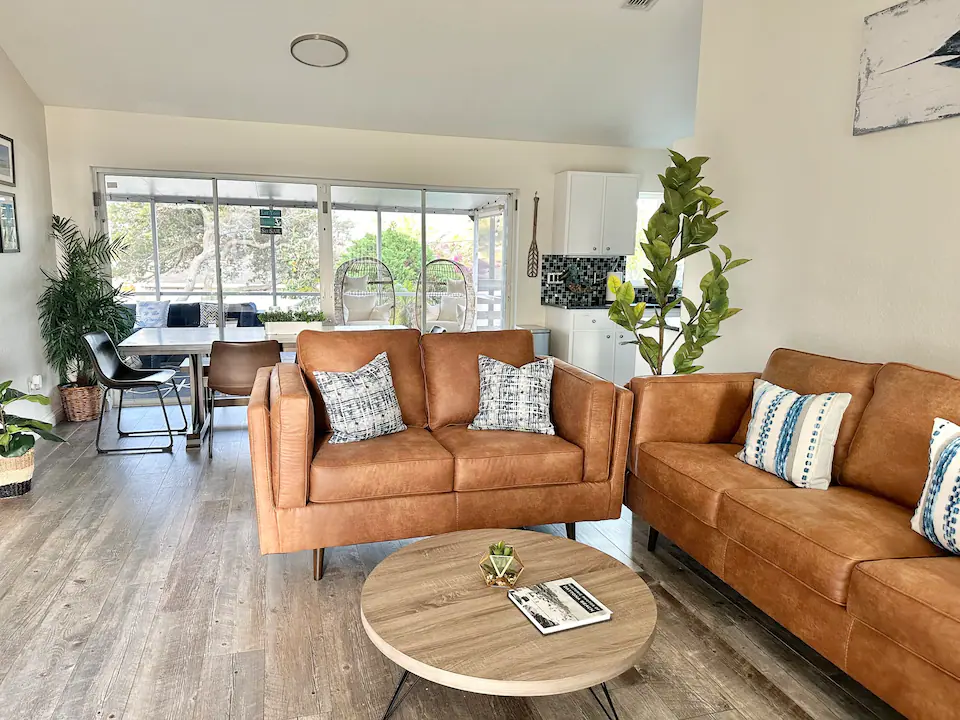 Immaculate coastal living area with tan leather sofas